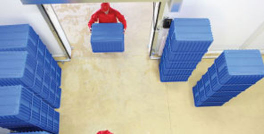 Birdseye view of man lifting boxes in a warehouse