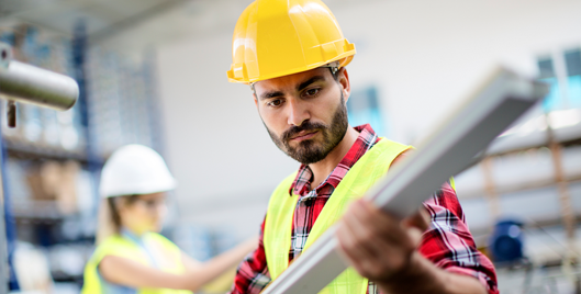 Employee working in hard hat and high vis vest