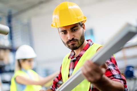 Employee working in hard hat and high vis vest