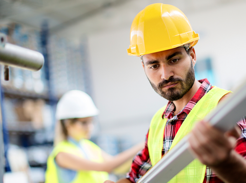 Employee working in hard hat and high vis vest