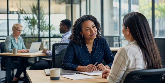 Employee discussing sick leave and family leave support with a manager in the workplace.