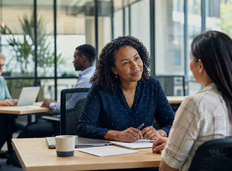 Employee discussing sick leave and family leave support with a manager in the workplace.