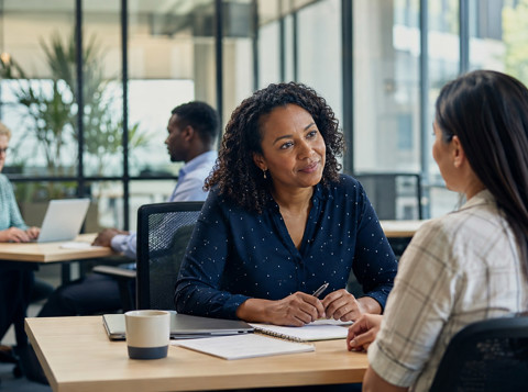 Employee discussing sick leave and family leave support with a manager in the workplace.