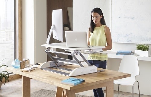 Alternating standing with sitting has been shown to have beneficial effects on blood glucose control, lessening back pain in those prone to it and reducing foot swelling. Photograph: Varidesk
