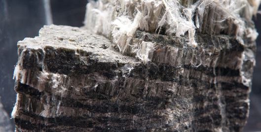Block of dark coloured asbestos