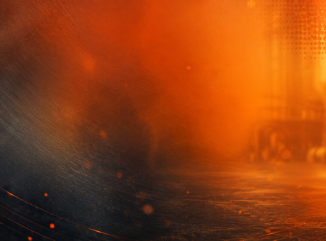 Abstract image of glowing embers, sparks and orange heat haze in a dark industrial environment, illustrating fire and heat hazards in the workplace.