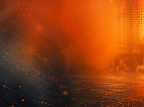 Abstract image of glowing embers, sparks and orange heat haze in a dark industrial environment, illustrating fire and heat hazards in the workplace.