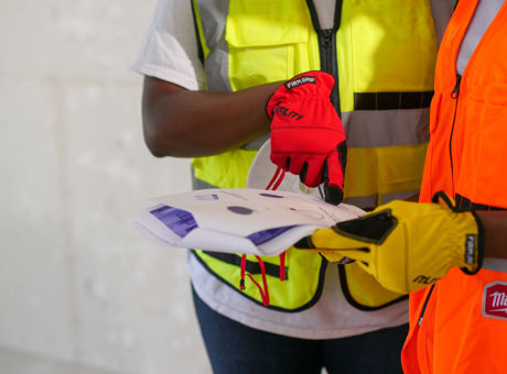 Workers reviewing health and safety documents during a workplace assessment