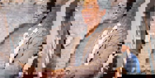 Woman smiling shaking someones hand