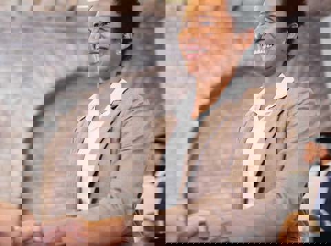 Woman smiling shaking someones hand