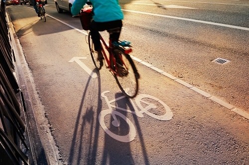 The UK government is urging people to use bicycles more to reduce air pollution, announcing a £2bn active travel fund