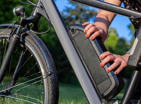 Person fitting an electric bike battery