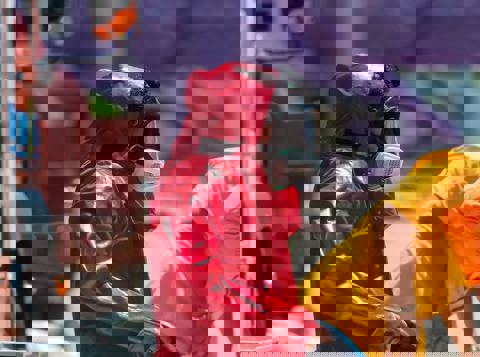 Worker wearing red hazmat suit