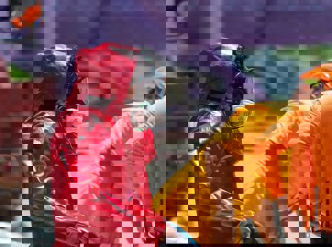 Worker wearing red hazmat suit