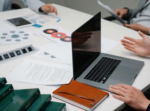 Colleagues reviewing documents during a workplace meeting