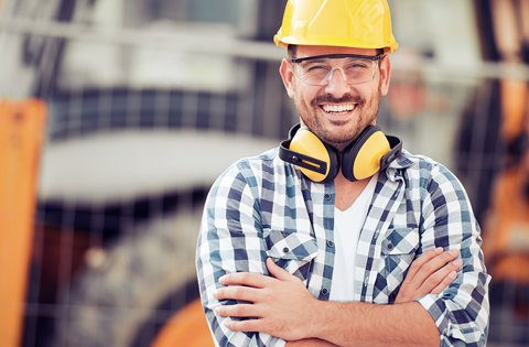 British Safety Council Membership - Man with hard hat, protective eyewear  and ear defenders around his neck smiling