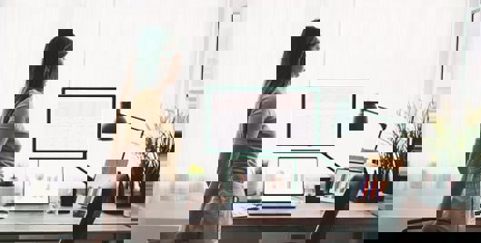 Woman taking a break from her work desk and stretching