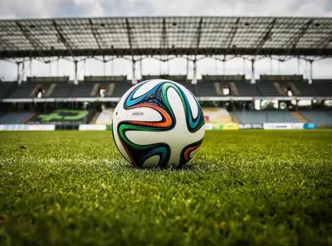 Football on a stadium pitch, representing heat stress risks and worker safety lessons from the 2026 FIFA World Cup