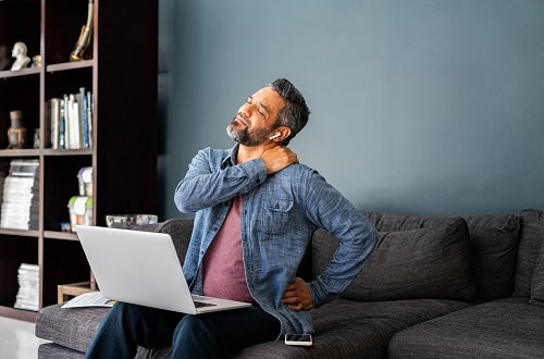 Office worker with neck pain iStock Ridofranz