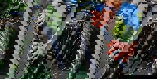 Person putting lithium ion battery on electric bike in a park