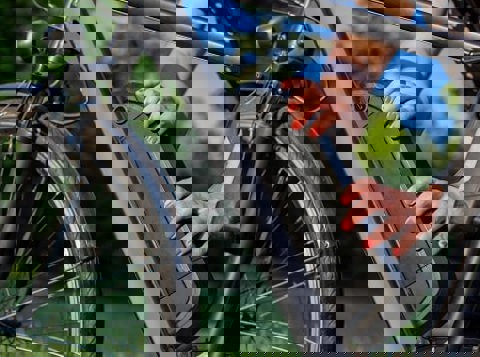 Person putting lithium ion battery on electric bike in a park